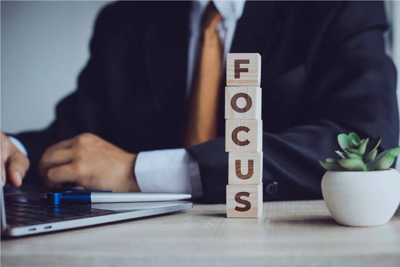 Wooden blocks spelling FOCUS on a desk