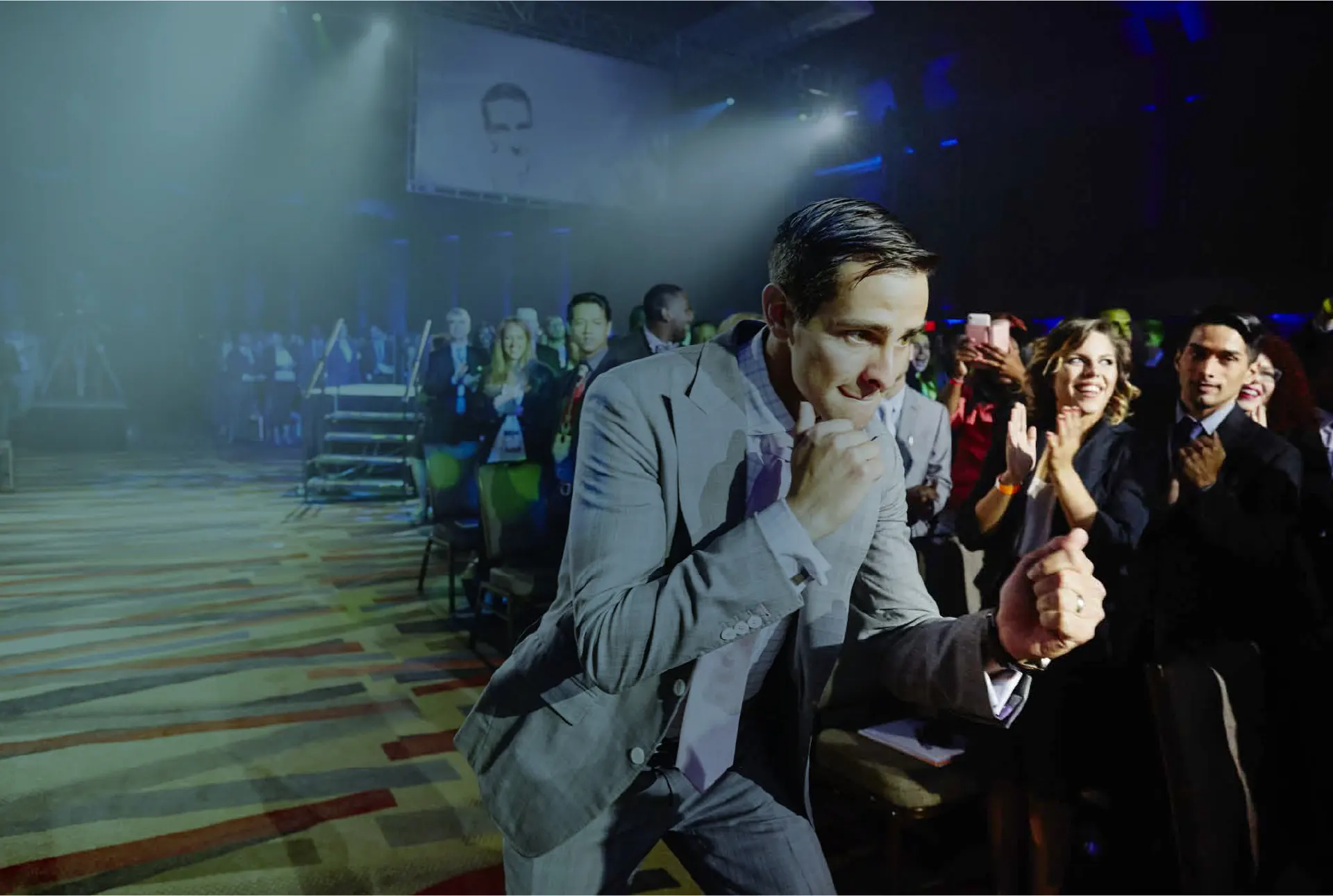 Ken Lear celebrating with the audience at a conference