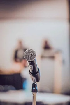 A microphone on a stand before a talk